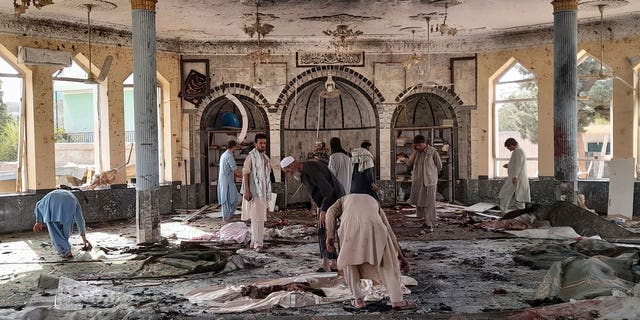 People see damage inside a mosque following a bombing in Kunduz, northern Afghanistan, on Friday, October 8, 2021 (AP Photo / Abdullah Sahil)