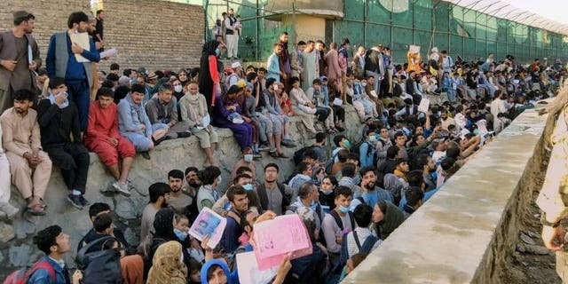 Crowds of people wait outside the airport in Kabul, Afghanistan, Aug. 25, 2021, in this photo obtained from social media. 