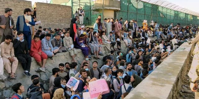 Crowds of people wait outside the airport in Kabul, Afghanistan, on Aug. 25, 2021, in this picture obtained from social media.