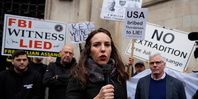 Julian Assange's partner, Stella Moris, addresses protestors outside the High Court in London on Oct. 27, 2021.
