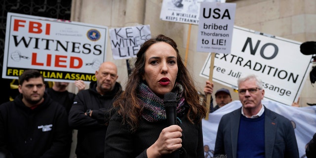 Julian Assange's partner, Stella Moris, addresses protestors outside the High Court in London on Oct. 27, 2021.