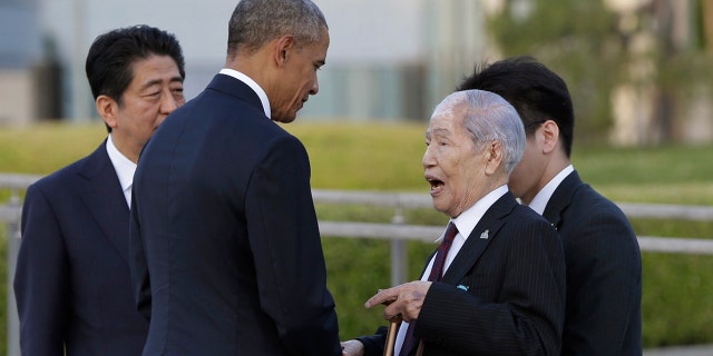 In this photo from May 2016, Sunao Tsuboi, right, a survivor of the 1945 atomic bombing and chairman of the Hiroshima Prefectural Confederation of A-bomb Sufferers Organization, talks with President Obama, center, accompanied by Japanese Prime Minister Shinzo Abe, left, at Hiroshima Peace Memorial Park in Hiroshima, western Japan.