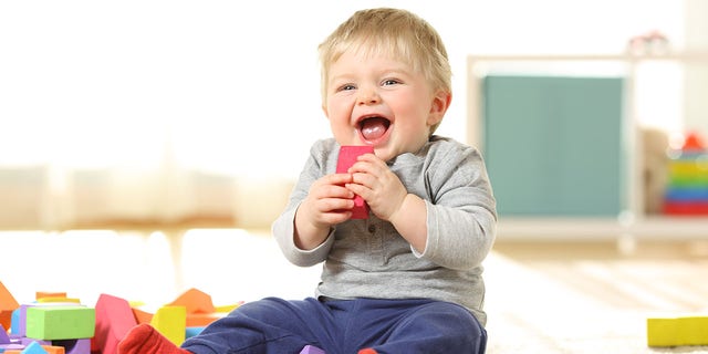 A baby laughs and plays with colorful toys at home. "Bonus points" if whatever you've done to make a baby laugh "is repeatable," said one Reddit user in answer to the question, "What is awesome, has always been awesome, and will forever be awesome?"