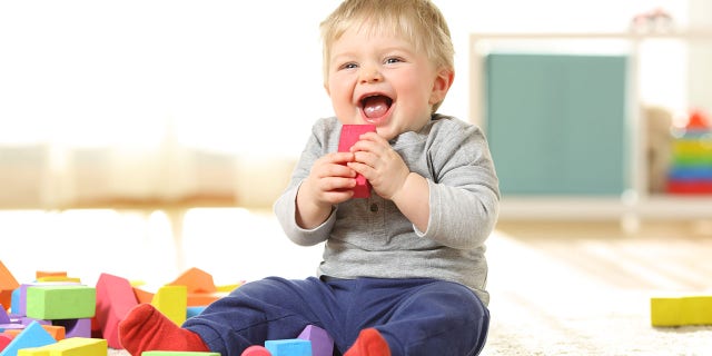 A baby laughs and plays with colorful toys at home. "Bonus points" if whatever you've done to make a baby laugh "is repeatable," said one Reddit user in answer to the question, "What is awesome, has always been awesome, and will forever be awesome?"