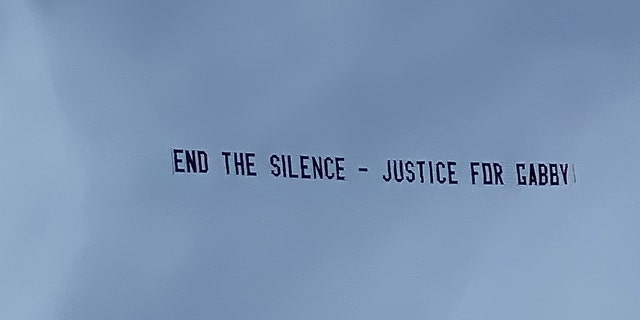 Justin Shepherd raised funds from his TikTok followers to fly this banner over Brian Laundrie's home in North Port, Fla.