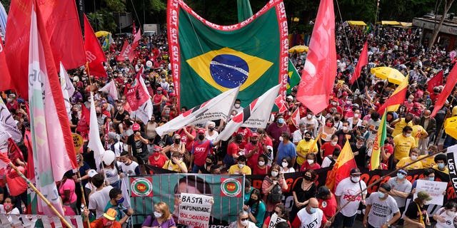 Demonstrators gather during a protest against Brazilian President Jair Bolsonaro, calling for his impeachment over his government's handling of the pandemic and allegations of corruption in the procurement of COVID-19 vaccines in Sao Paulo, Brazil, Saturday, Oct. 2, 2021. Mr.