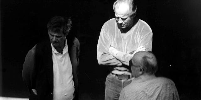 This 1980 surveillance photo released by the U.S. Attorney's Office and presented as evidence during the first day of a trial for James "Whitey" Bulger in U.S. District Court in Boston, June 12, 2013, shows Bulger, center, with Ted Berenson, left, and Phil Wagenheim at a Lancaster Street garage in Boston's North End.