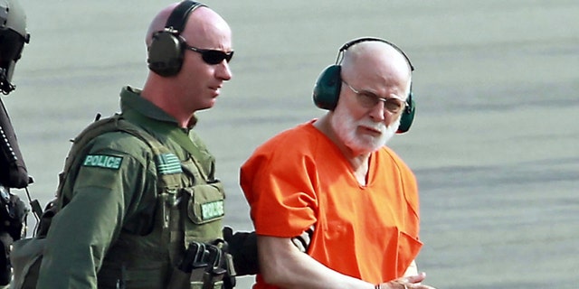 FILE - In this June 30, 2011 file photo, James "Whitey" Bulger, right, is escorted from a U.S. Coast Guard helicopter to a waiting vehicle at an airport in Plymouth, Mass., after attending hearings in federal court in Boston.