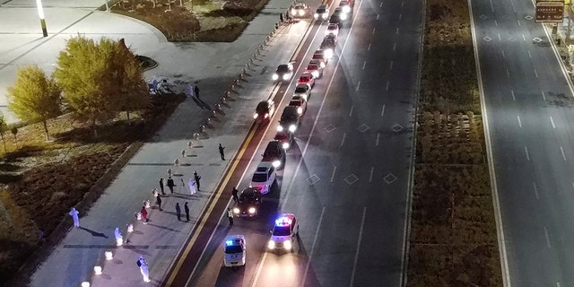 In this aerial photo released by Xinhua News Agency, stranded self-driving tourists prepare to leave Alxa League's Ejina Banner for two-week quarantine hotels on Thursday in the Inner Mongolia Autonomous Region of the northern China.