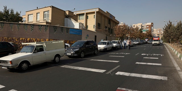 Cars wait in line to fill up at a gas station because pumps machines are out of service in Tehran, Iran on Oct. 26.