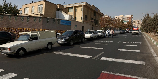 Cars wait in line to fill up at a gas station because pumps machines are out of service in Tehran, Iran on Oct. 26.
