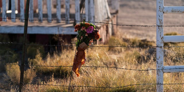 A bouquet of flowers is left to honor cinematographer Halyna Hutchins outside the Bonanza Creek Ranch.