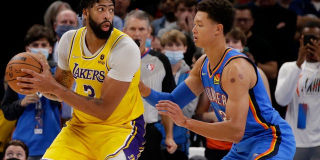 Los Angeles Lakers forward Anthony Davis (3) goes against Oklahoma City Thunder center Isaiah Roby (22) during the second half of an NBA basketball game, Wednesday, Oct. 27, 2021, in Oklahoma City.
