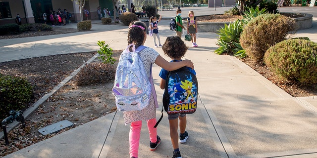 Tustin, CA - August 12: Students make their way to class for the first day of school at Tustin Ranch Elementary School in Tustin, CA on Wednesday, August 11, 2021. 
