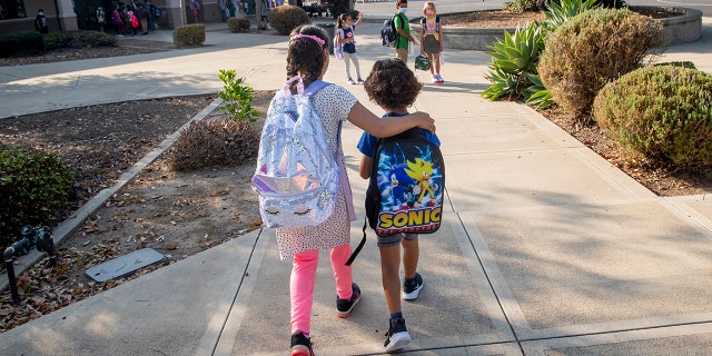 Tustin, CA - August 12: Students make their way to class for the first day of school at Tustin Ranch Elementary School in Tustin, CA on Wednesday, August 11, 2021. 