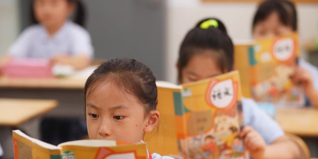Children attend an elementary school in September in Nanjing, China's Jiangsu Province. The Chinese parliament this week will consider a new law that, if passed, would punish parents for their children's misbehavior.