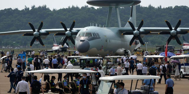 Visitors look at the Chinese military's KJ-500 airborne early warning and control aircraft during 13th China International Aviation and Aerospace Exhibition, also known as Airshow China 2021, on Wednesday, Sept. 29, 2021, in Zhuhai in southern China's Guangdong province. With record numbers of military flights near Taiwan over the last week, China has been stepping up its harassment of the island it claims as its own, showing an new intensity and sophistication as it asserts its territorial claims in the region. (AP Photo/Ng Han Guan