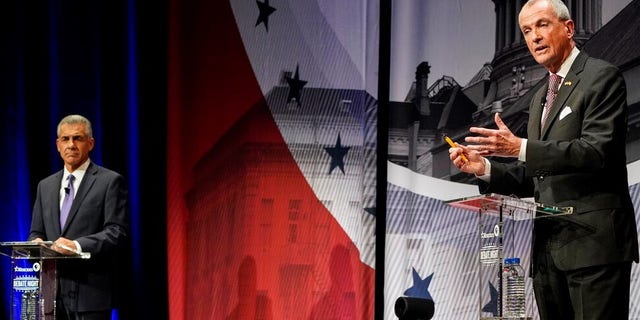 Incumbent Gov. Phil Murphy, D-N.J., right, speaks while Republican challenger Jack Ciattarelli listens during a gubernatorial debate at Rowan University's Pfleeger Concert Hall Tuesday, Oct. 12, 2021, in Glassboro, N.J. (AP Photo/Frank Franklin II, Pool)
