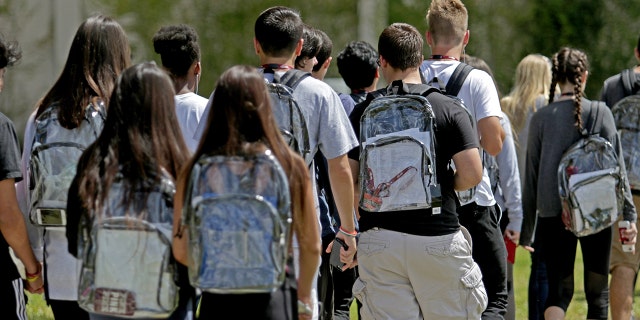 Students wear clear backpacks outside of Marjory Stoneman Douglas High School in Parkland, Florida, on Monday, April 2, 2018. (John McCall/Sun Sentinel/Tribune News Service via Getty Images)