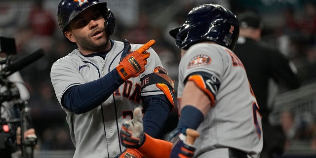 Houston Astros' Jose Altuve celebrates his home run with Alex Bregman during the fourth inning in Game 4 of baseball's World Series between the Houston Astros and the Atlanta Braves Saturday, Oct. 30, 2021, in Atlanta.