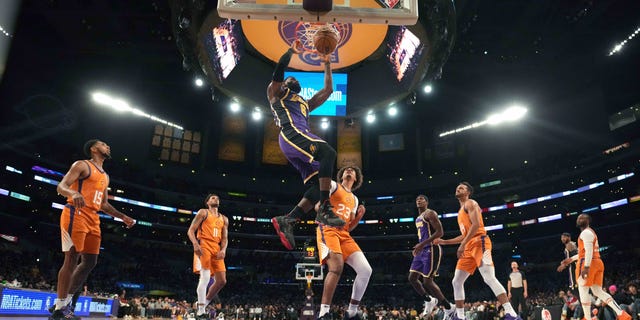 Los Angeles Lakers forward LeBron James (6) dunks the ball as Phoenix Suns guard Cameron Payne (15), forward Abdel Nader (11), forward Cameron Johnson (23), guard Landry Shamet (14) and guard Chris Paul (3) watch in the second half at Staples Center Oct 22, 2021. The Suns defeated the Lakers 115-105.