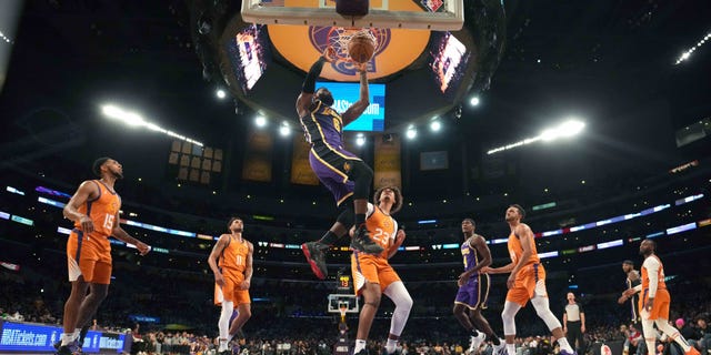 Los Angeles Lakers forward LeBron James (6) dunks the ball as Phoenix Suns guard Cameron Payne (15), forward Abdel Nader (11), forward Cameron Johnson (23), guard Landry Shamet (14) and guard Chris Paul (3) watch in the second half at Staples Center Oct 22, 2021. The Suns defeated the Lakers 115-105.