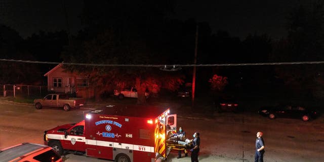 Houston Fire Department EMS medics load a COVID-positive patient into an ambulance Aug. 20, 2021 in Houston, Texas.. (Photo by John Moore/Getty Images)