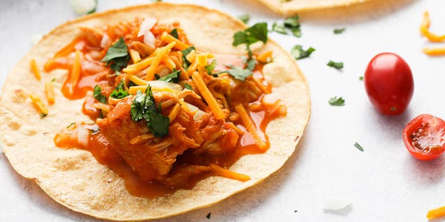Chelsea Plummer's Instant Pot chicken taco recipe includes salsa, yellow onions, tomato paste and delectable seasonings.