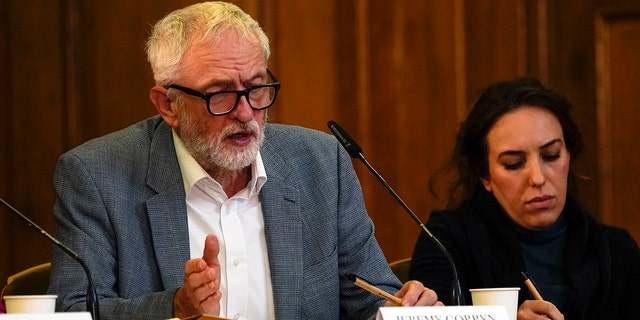 Britain's former leader of the Labour Party Jeremy Corbyn, left, and Stella Moris, partner of Julian Assange, attend the "Belmarsh Tribunal" at Church House in London on Oct. 22, 2021. 
