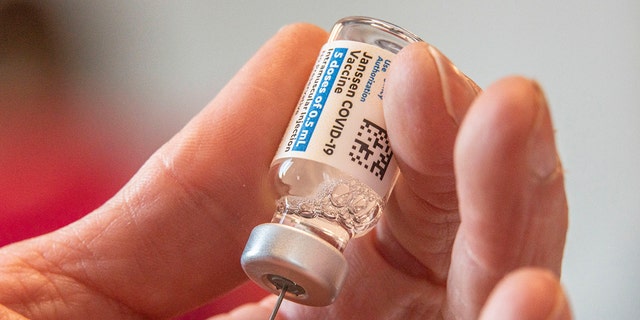 Director of Nursing Crystal Jones, 52, loads syringes with the COVID-19 vaccine.