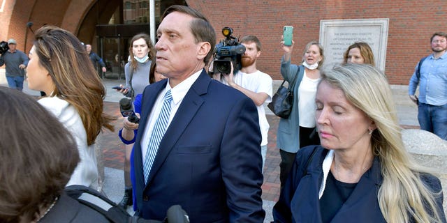 John Wilson, center, and his wife leave federal court after being convicted of participating in a fraudulent college admissions program on Friday, October 8, 2021 in Boston.  Wilson and another wealthy relative, Gamal Abdelaziz, were convicted on Friday of buying their children's way to school as sports recruits in the first case to stand trial in the admission fraud scandal at the university which involved prestigious universities across the country.  (AP Photo / Josh Reynolds)