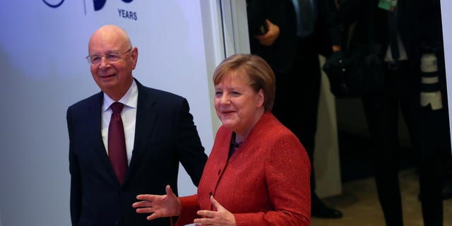 German Chancellor Angela Merkel arrives with Klaus Schwab, Founder and Executive Chairman of World Economic Forum, to deliver a special address at the 50th World Economic Forum (WEF) annual meeting in Davos, Switzerland, January 23, 2020. REUTERS/Denis Balibouse