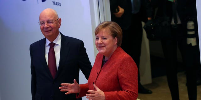 German Chancellor Angela Merkel arrives with Klaus Schwab, Founder and Executive Chairman of World Economic Forum, to deliver a special address at the 50th World Economic Forum (WEF) annual meeting in Davos, Switzerland, January 23, 2020. REUTERS/Denis Balibouse