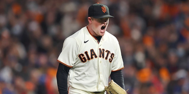 San Francisco Giants pitcher Logan Webb reacts after hitting the Los Angeles Dodgers' Trea Turner during the sixth inning of Game 1 of a baseball National League Division Series on Friday, October 8, 2021, in San Francisco.  (AP Photo / John Hefti)