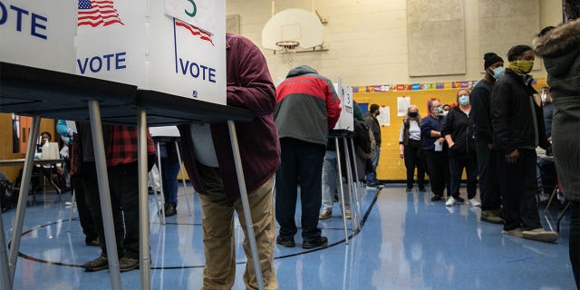 Michigan voters fill out their ballots at a school gymnasium on Nov. 03, 2020, in Lansing.