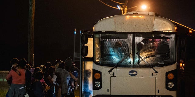 Migrants board a bus in Westchester, New York, in October 2021.