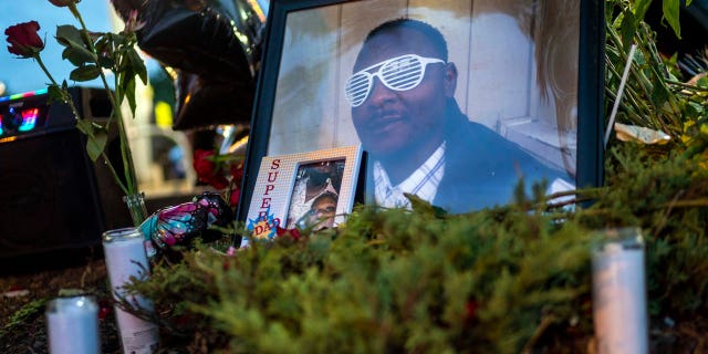 in this July 7, 2021 file photo, Items rest at a memorial for Leneal Lamont Frazier, in Minneapolis, at the site of his death. Frazier died early Tuesday, July 6, after his vehicle was struck by a squad car that police said was pursuing another driver linked to several robberies. A Minneapolis police officer has been charged with manslaughter and vehicular homicide in a fatal crash in July that occurred while the officer was pursuing a stolen vehicle, a prosecutor announced Friday, Oct. 22, 2021. (Antranik Tavitian/Star Tribune via AP File)