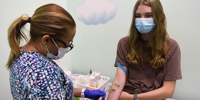 Clinical Research Coordinator Jeanette DeLeon takes blood samples from 16-year-old Brooke Stroud, a patient in a Moderna COVID-19 vaccine clinical trial for adolescents being conducted by Accel Research Sites with Nona Pediatric Center in Orlando, Florida. 