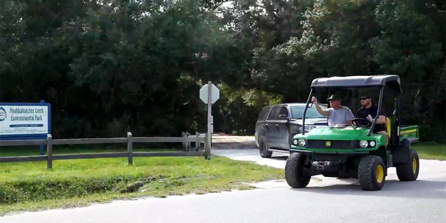 Christopher Laundrie is escorted by law enforcement to Myakkahatchee Creek Environmental Park.  (Fox News)