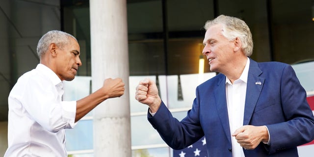 Virginia Democratic gubernatorial candidate Terry McAuliffe fist bumps former U.S. President Barack Obama during his campaign rally in Richmond, Virginia, U.S. October 23, 2021. REUTERS/Kevin Lamarque