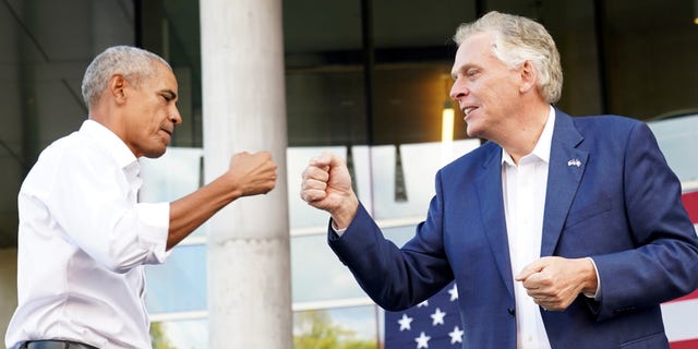 Virginia Democratic gubernatorial candidate Terry McAuliffe fist bumps former U.S. President Barack Obama during his campaign rally in Richmond, Virginia, U.S. October 23, 2021. REUTERS/Kevin Lamarque