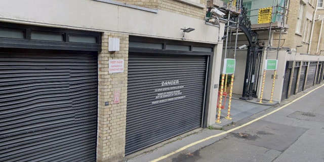 The non-descript garage door leads into an alley.