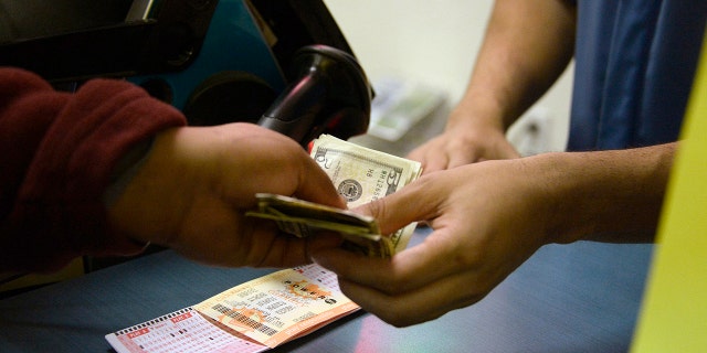 Customers buy lottery tickets for Powerball at a CA Lotto store in San Bernardino County, California, in January 2016.  