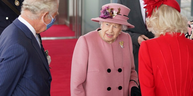Britain's Queen Elizabeth II, accompanied by Prince Charles and Camilla, Duchess of Cornwall, second right, attends the opening ceremony of the sixth session of the Senedd in Cardiff, Wales, Thursday Oct. 14.