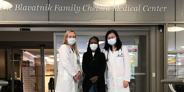 From left, Dr. Sarah Cate, director of the special surveillance and breast program at Mount Sinai Beth Israel; patient Woobie Rust and Dr. Theresa Shao, hematology and oncology specialist, stand in front of the Chelsea Medical Center at Mount Sinai where Rust receives her cancer care.