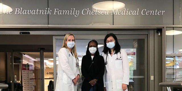 From left, Dr. Sarah Cate, director of the special surveillance and breast program at Mount Sinai Beth Israel; patient Woobie Rust and Dr. Theresa Shao, hematology and oncology specialist, stand in front of the Chelsea Medical Center at Mount Sinai where Rust receives her cancer care.