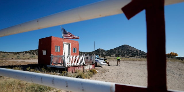 Private security stand at the entrance of the Bonanza Creek Film Ranch in Santa Fe, New Mexico.