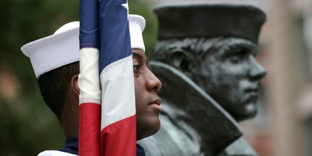 A member of the Navy Ceremonial Guard stands for the national anthem during a ceremony for National POW/MIA Recognition Day. (Photo by Kevin Dietsch/Getty Images)