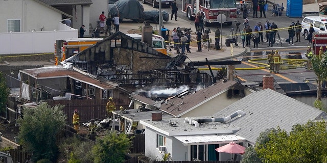 Emergency personnel work at the scene of a small plane crash Monday in Santee, California (AP Photo / Gregory Bull)