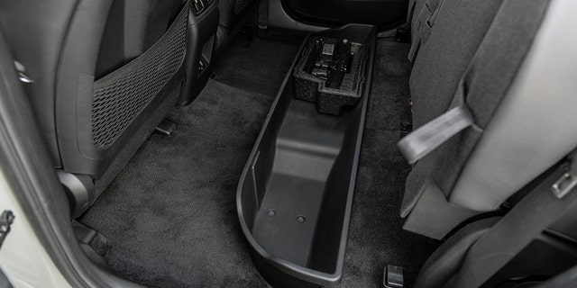 A storage compartment is hidden under the rear seats.